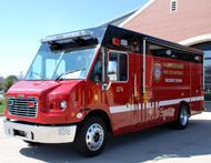 A large red truck with a black roof.