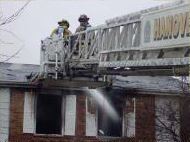 Firefighters on an extended ladder.